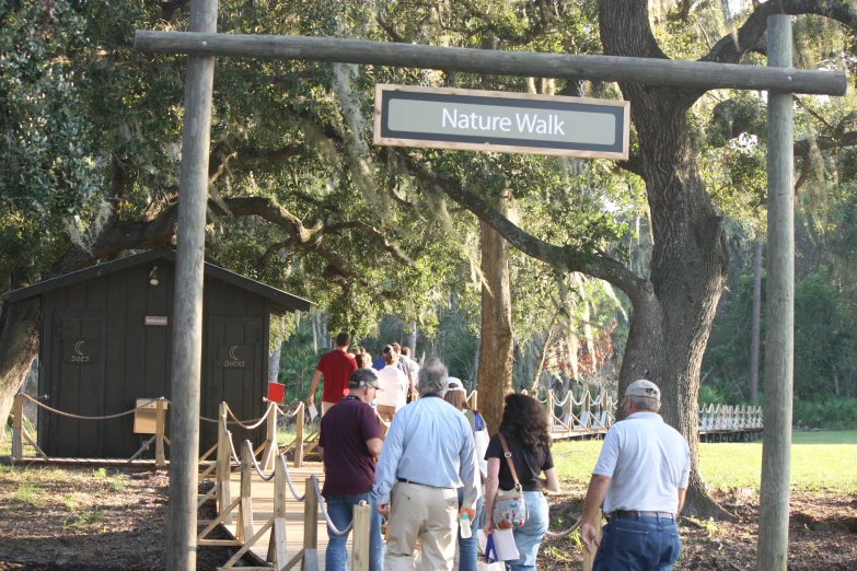 people walking in the nature walk area of a park