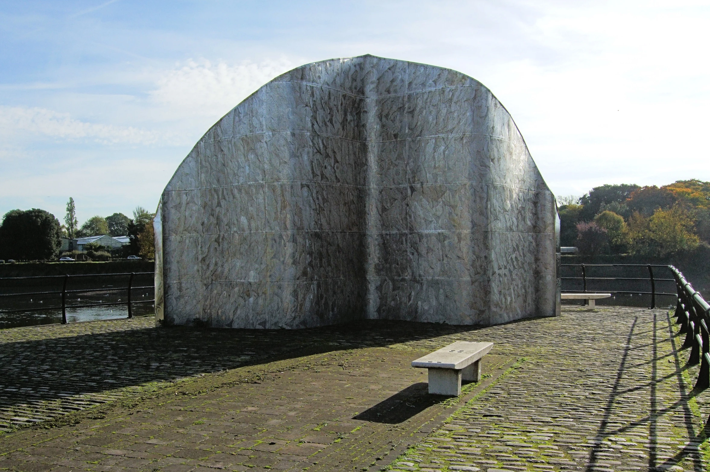 a large metal structure sitting in the middle of an empty field