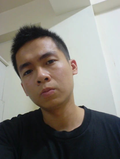 a man in black shirt looking directly into the camera