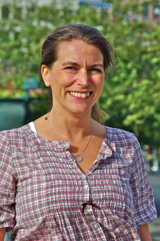 the woman is posing for the camera while she is smiling