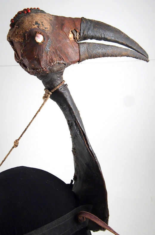 a bird head and beak are depicted with red eyeball eyes