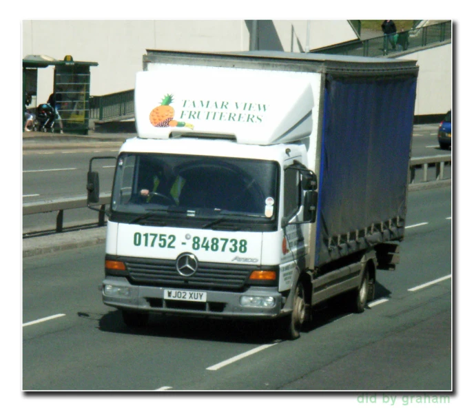 an image of a white truck going down the road