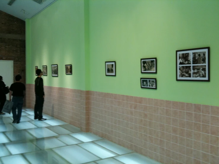 a hallway with pictures hanging on the wall