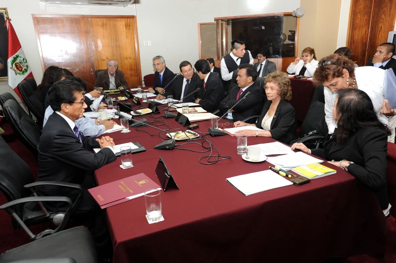 several people sitting at long tables in business attire