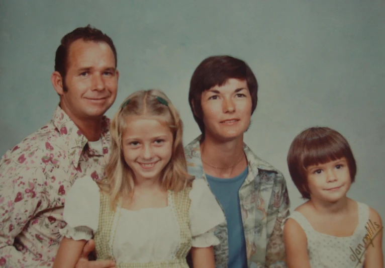 a young woman with her two children is posing for a family picture