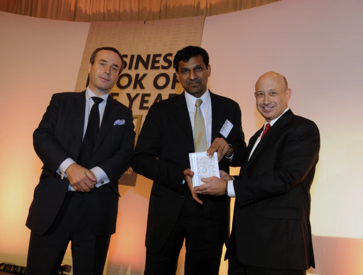 three men in suits standing beside each other