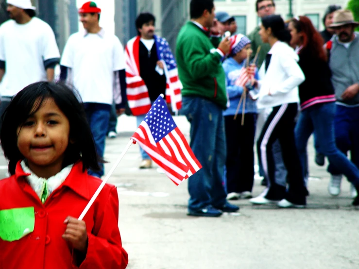 a  is holding two american flags