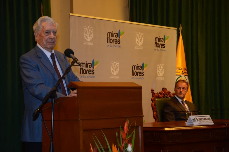 a man in a suit and tie is giving a speech