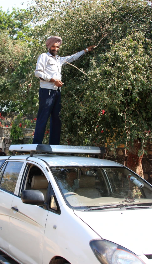 a man standing on top of a parked car