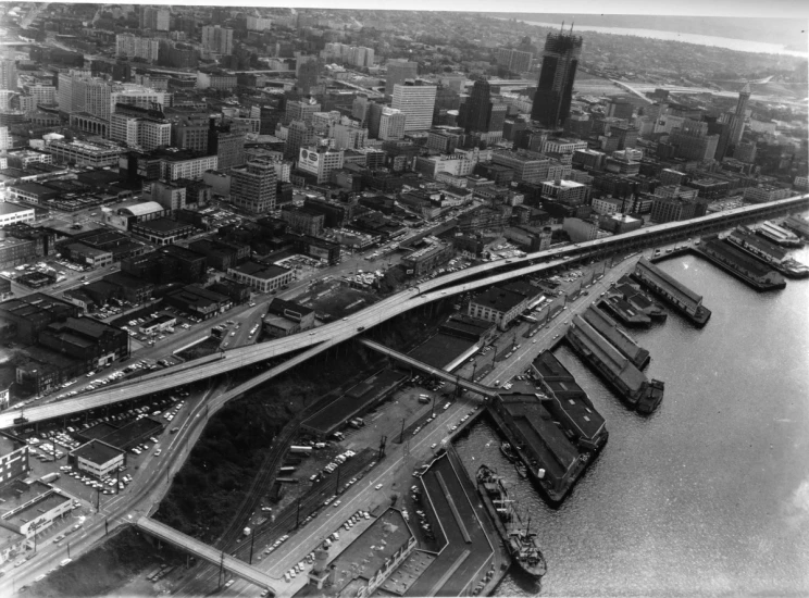 an aerial view of a city, a bridge and waterway