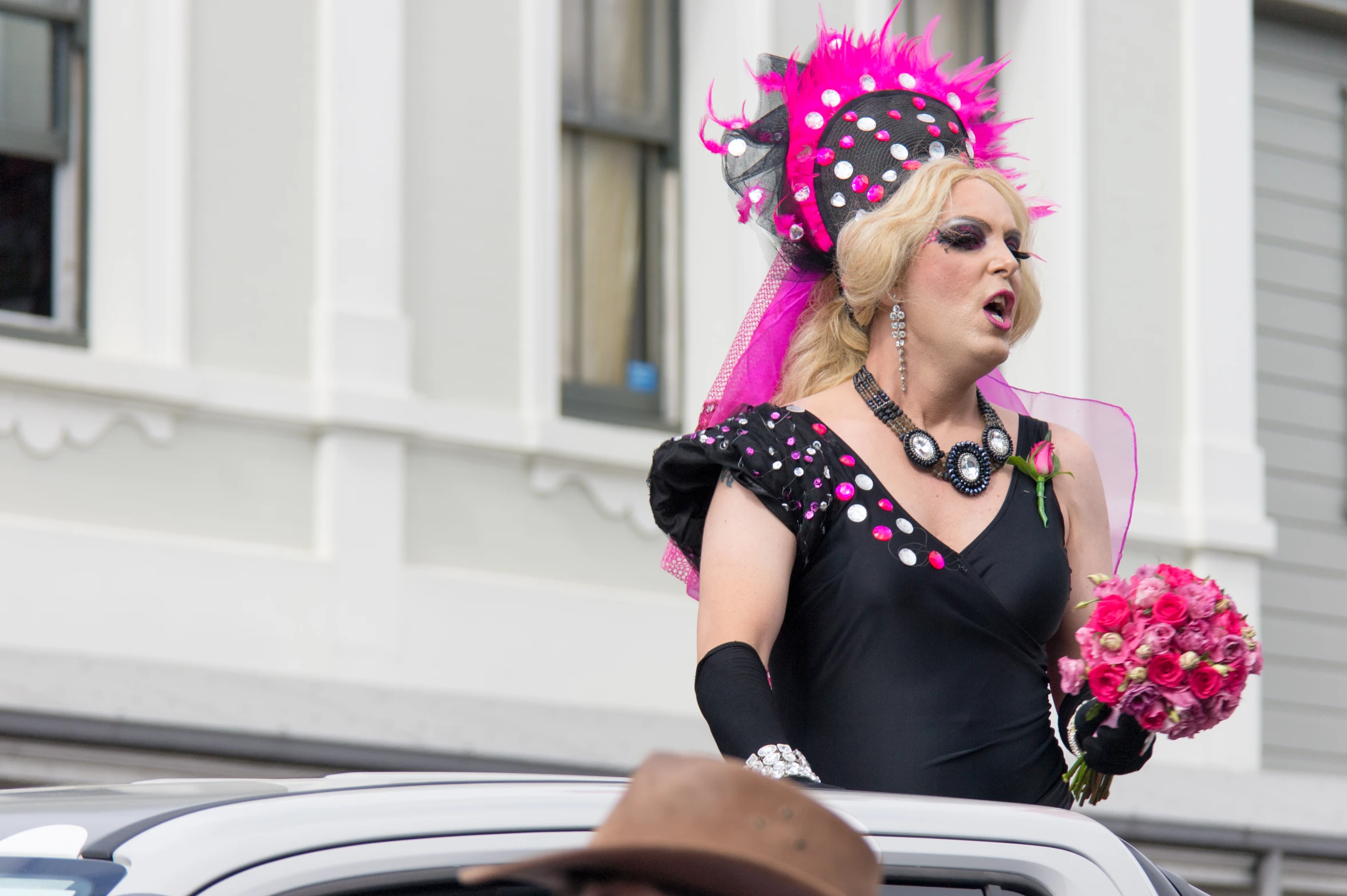 woman in pink and black outfit holding flowers