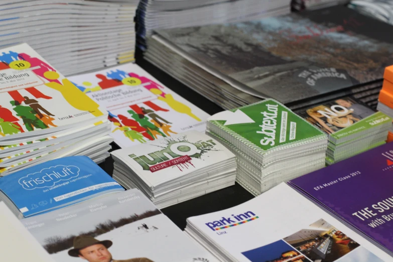 many pamphlets are stacked in rows next to each other