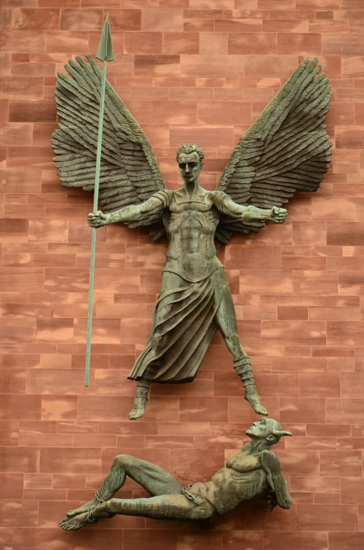 there is a statue in the shape of an angel on a wall