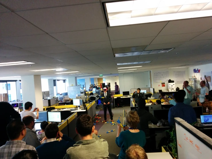 an office filled with employees looking at their computers