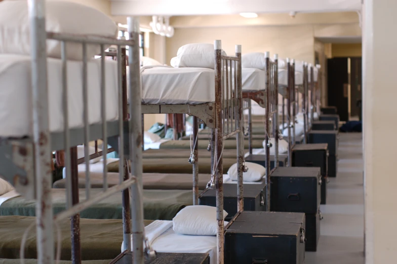 a row of bunk beds and some blankets