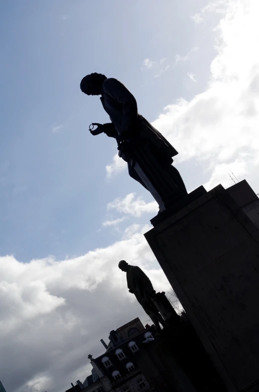 the statue is located near a tall building