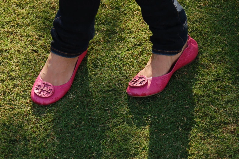 a close - up of a persons feet wearing pink shoes