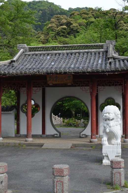 a small building with a lion statue in front