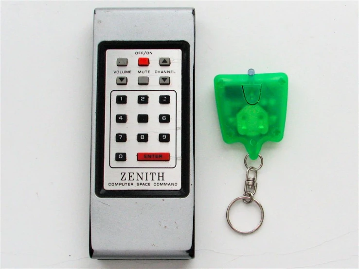 the green control keychain is next to a mechanical key chain