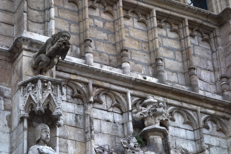 the gargoyle on the balcony of this ornate building is perched on