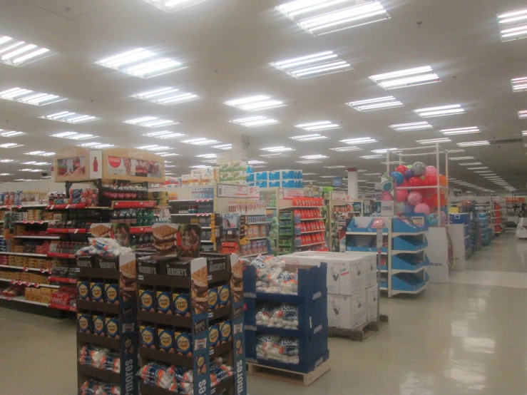 the inside of a grocery store with many goods displayed