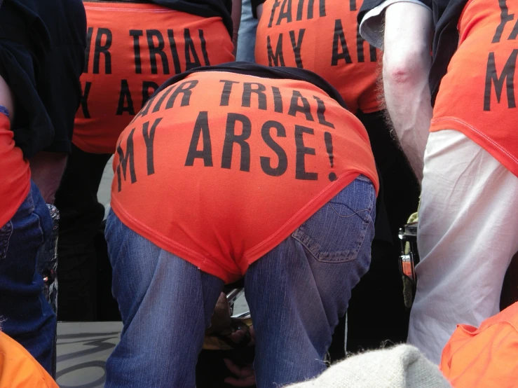 a group of people in orange vests with the word i hate them