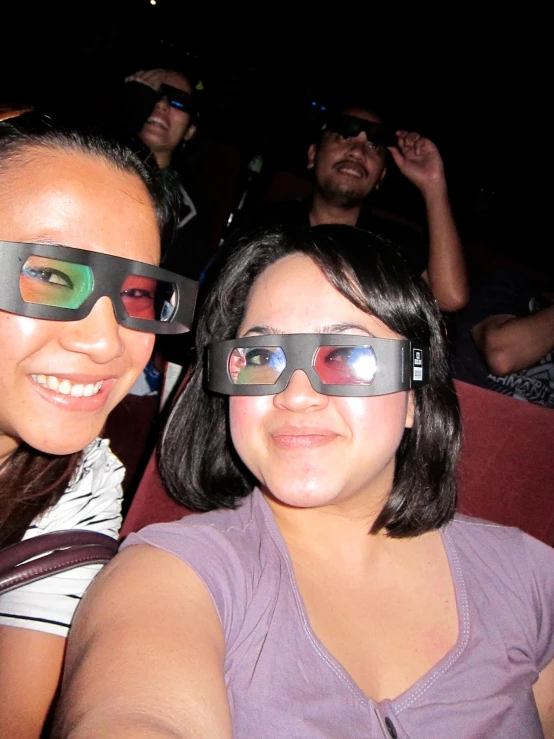 two people wearing google glasses while sitting down