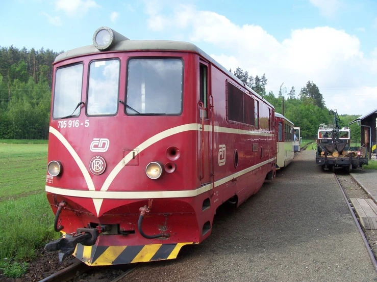 a red and yellow train traveling down the tracks