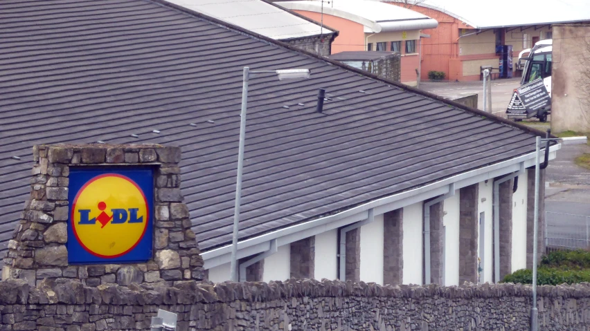 the large mcdonald's sign is above a stone wall