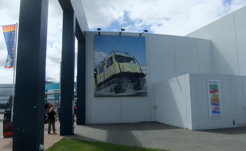 a large painting of a train sitting in a white wall