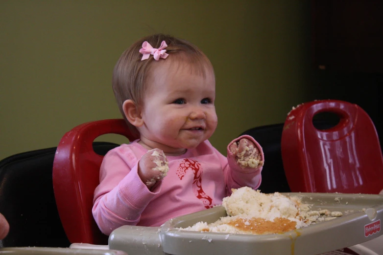 small child sitting at the table with food