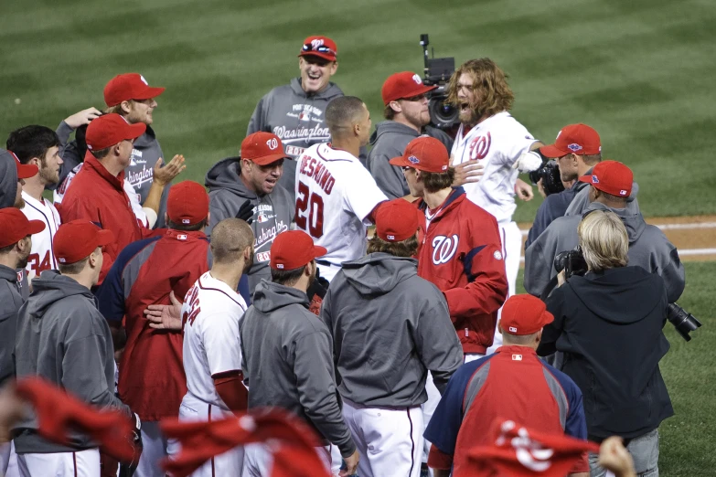 baseball players in a group standing around each other