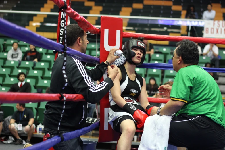 the young man is taking a punch on the face of the referee