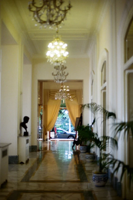 the hallway leading to a large, elegant suite with yellow curtains