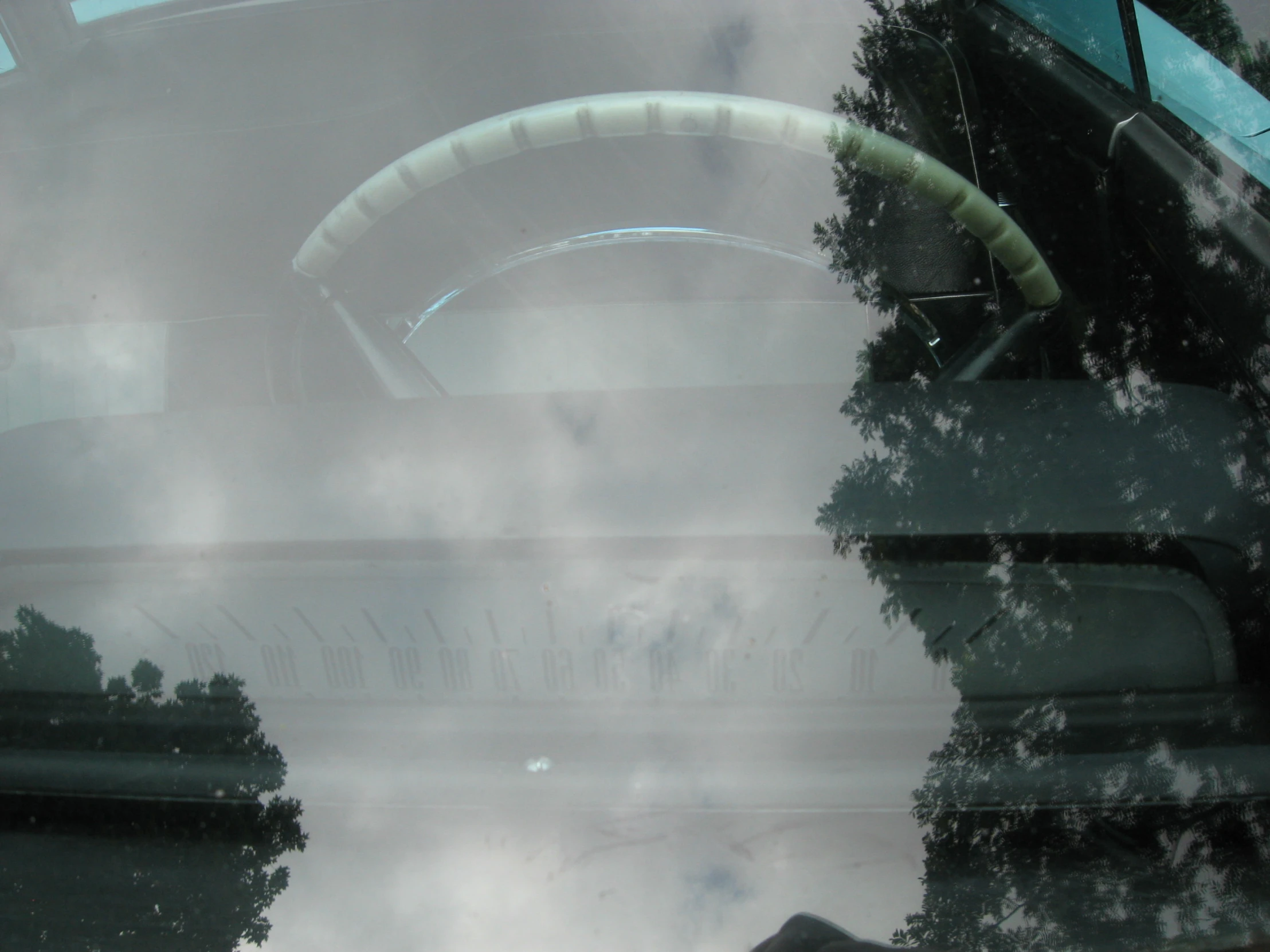 the dashboard of a car shows some clouds and trees