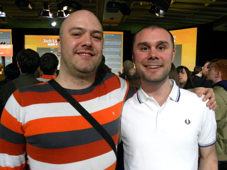 two men standing next to each other at an event