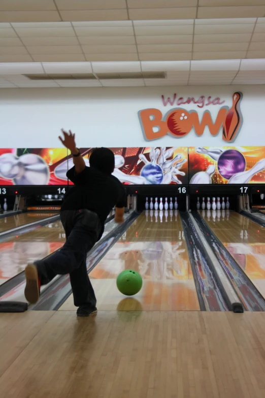 a person standing in the middle of bowling pins