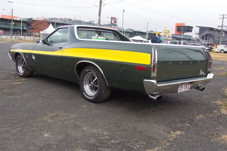 an older car with yellow stripes is parked