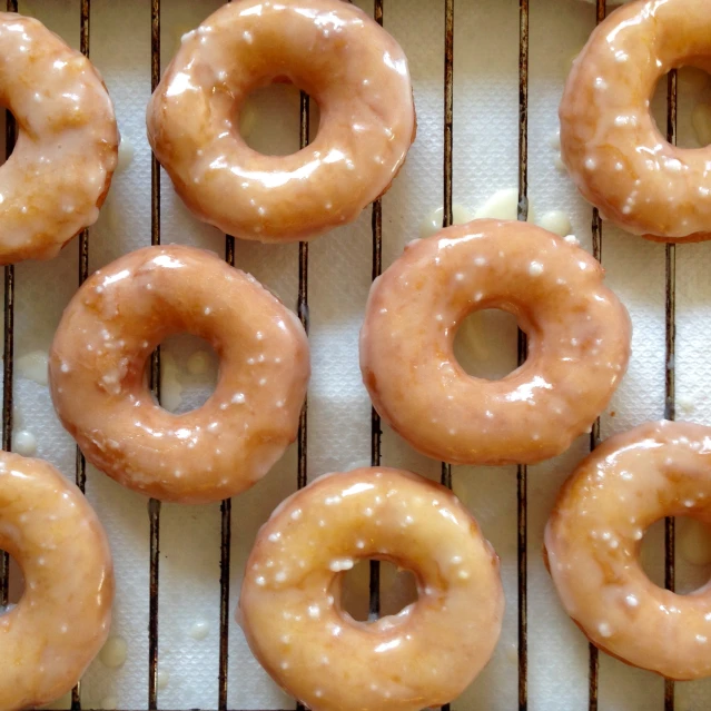 six donuts sitting on top of a cooling rack