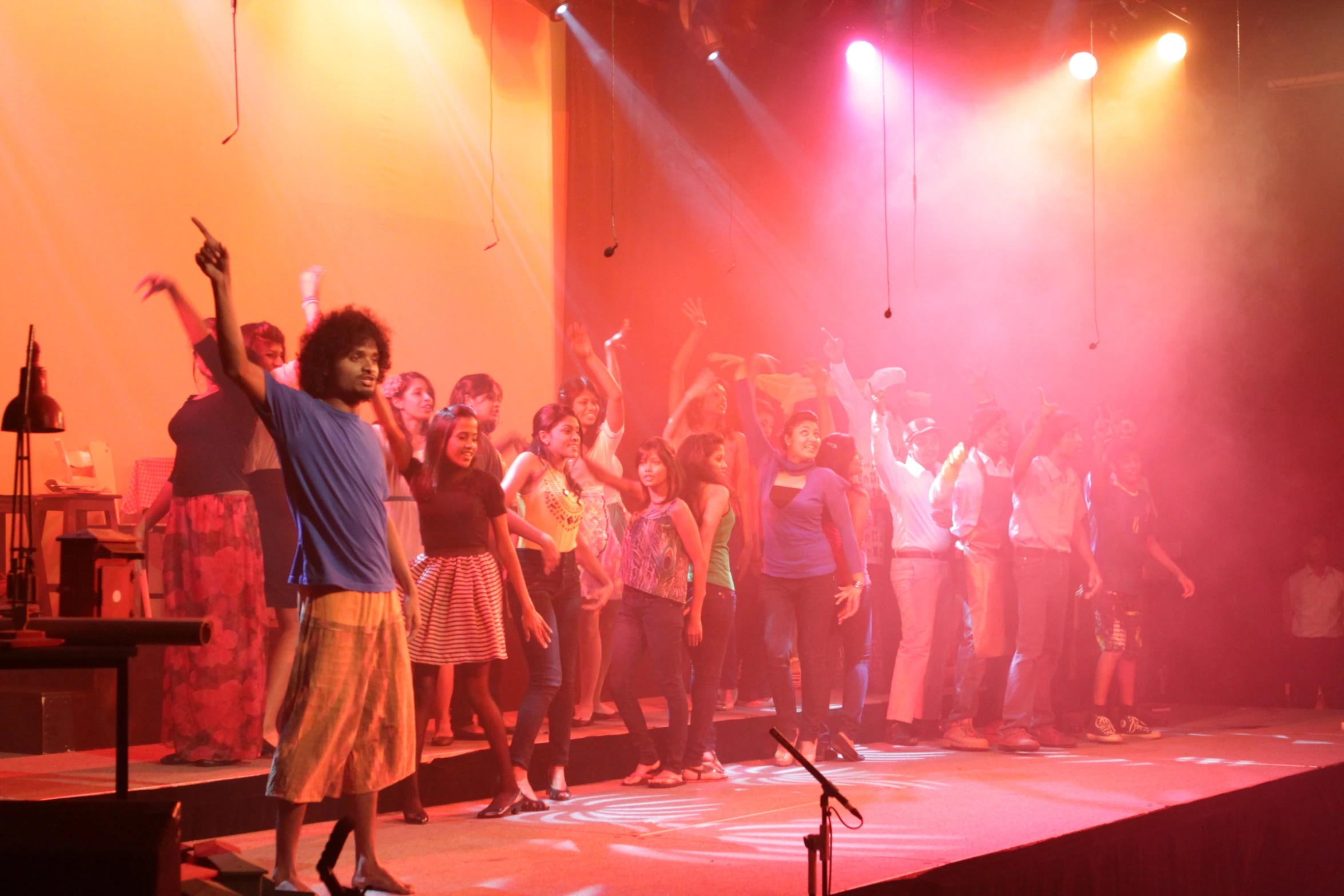 a group of people watching an audience on stage