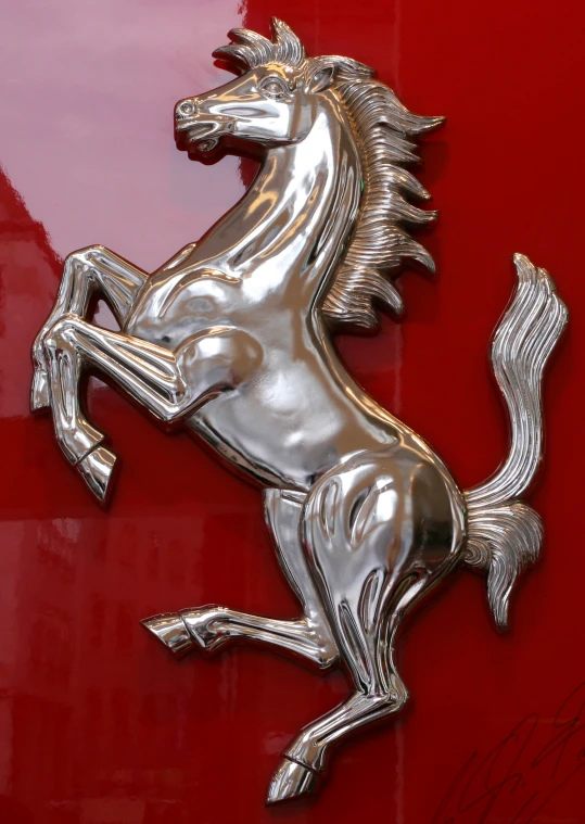 the emblem on the front of a red ferrari