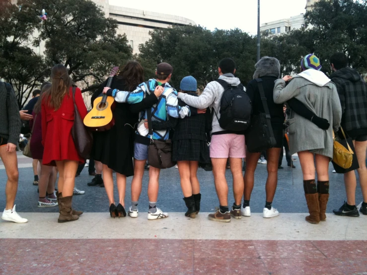 a group of young people standing in line next to each other