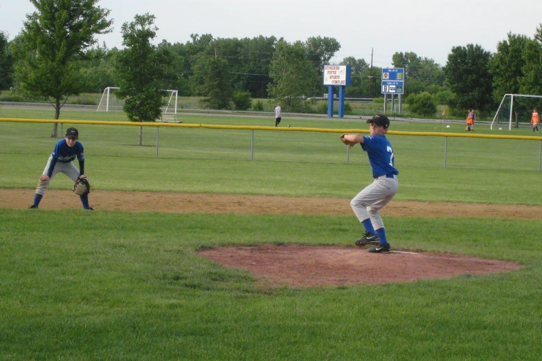 baseball players playing in a park near a field