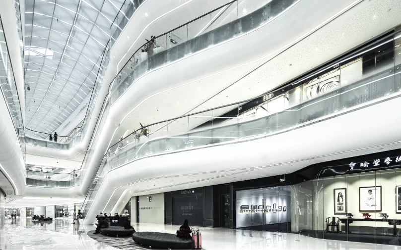 an empty lobby in a large building with lights