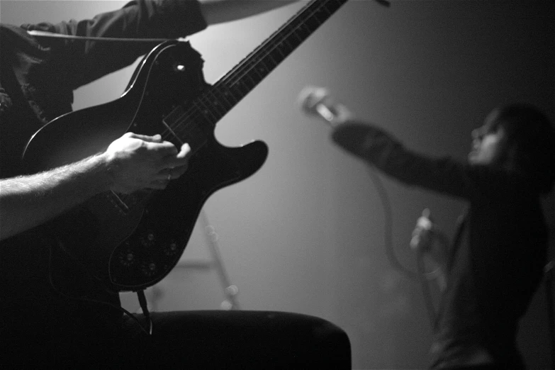 black and white image of the man playing a guitar