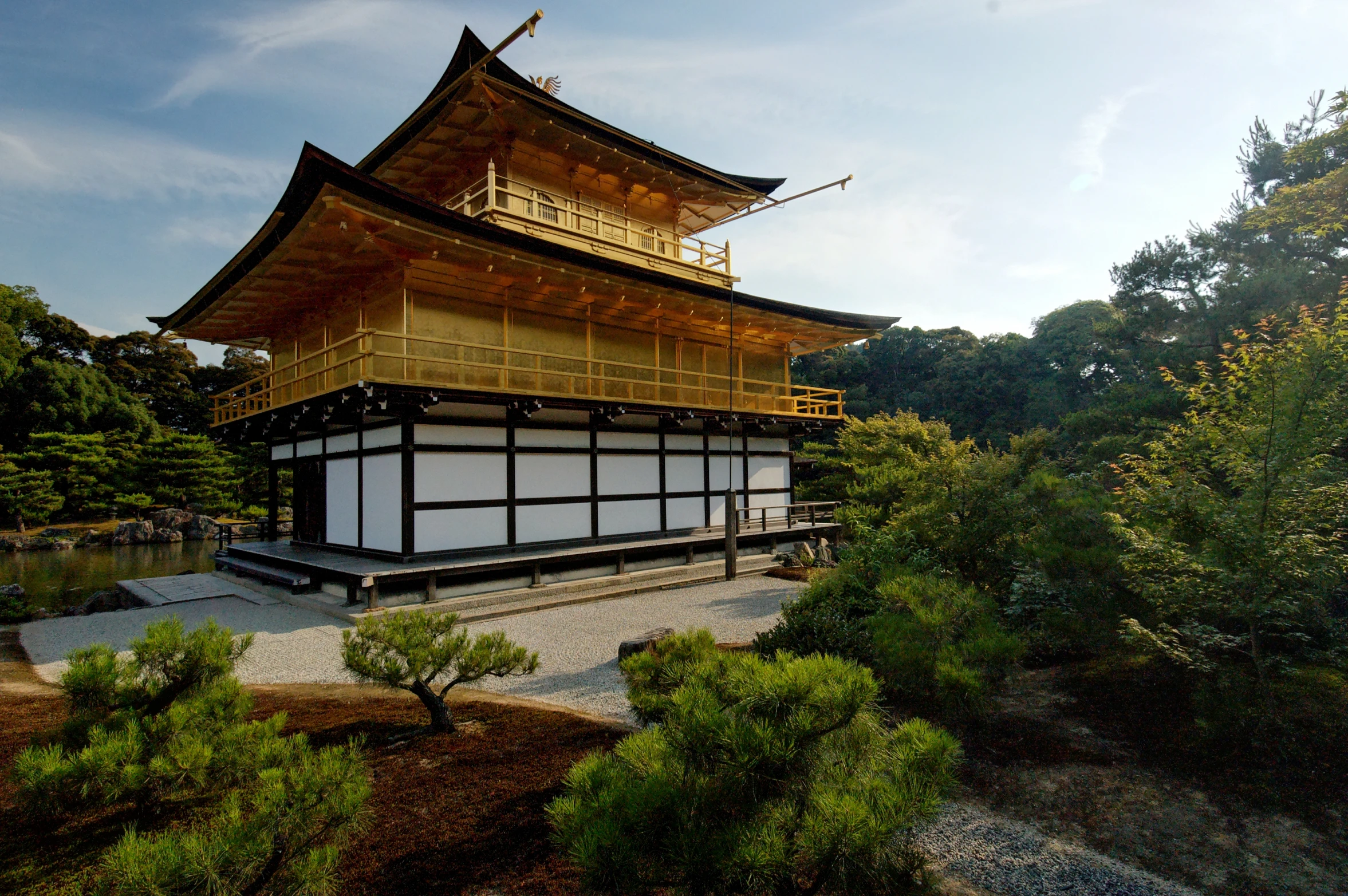 a tall pagoda near a small body of water