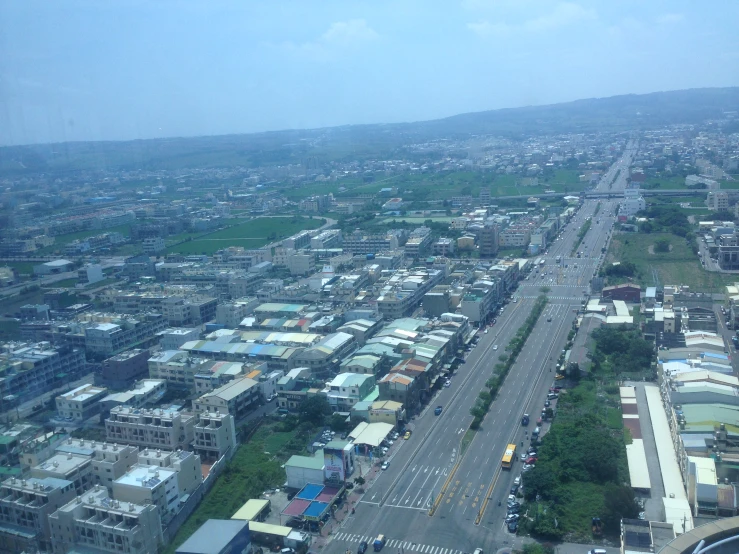 the town has tall buildings, lots of traffic and a blue sky