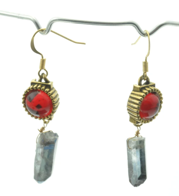 a pair of earrings hanging off a hook