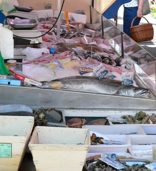 a woman is looking at an assortment of seafood