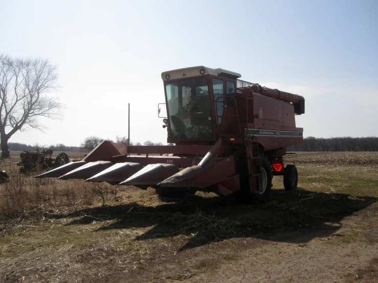 a tractor moving along a trail near a field